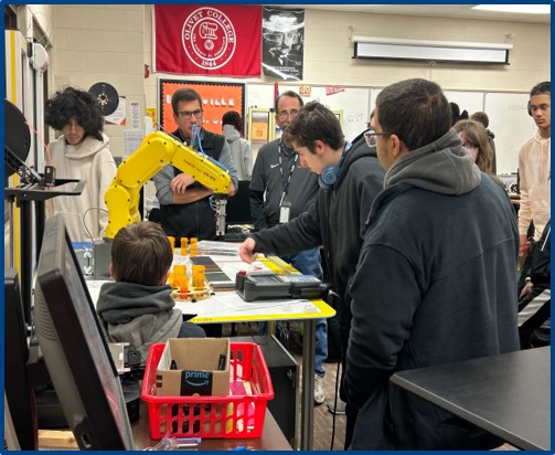 Students gathered around a table in a classroom