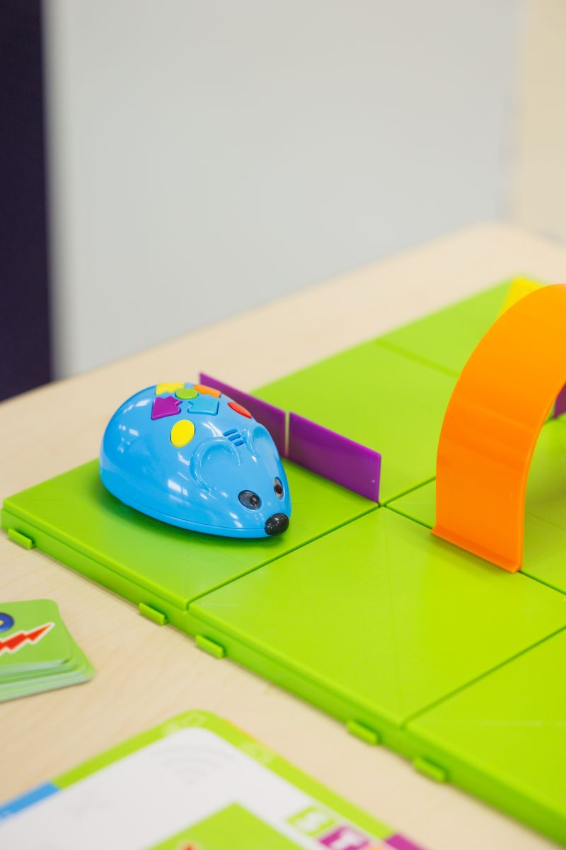 A plastic mouse sitting on a green board