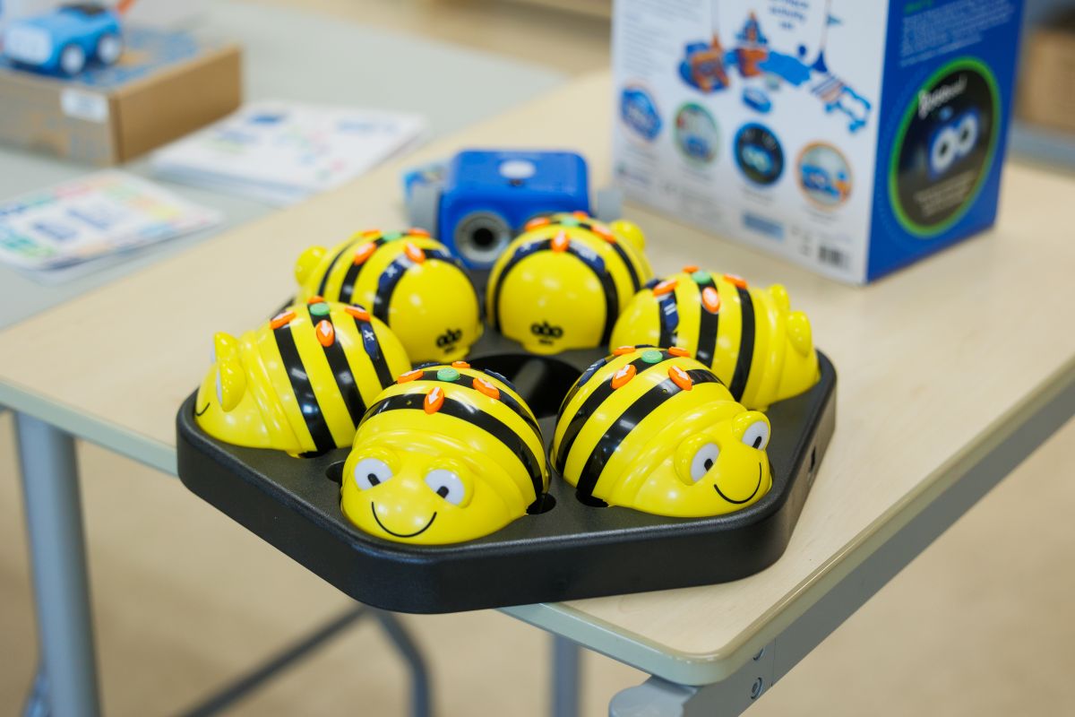 Yellow plastic bees on a black board
