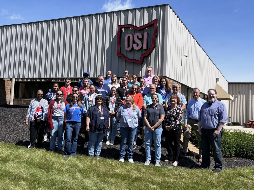 Teachers in the Battelle Teacher Academy cohort gather outside the Ohio Semitronics manufacturing facility during a Year 4 site visit.