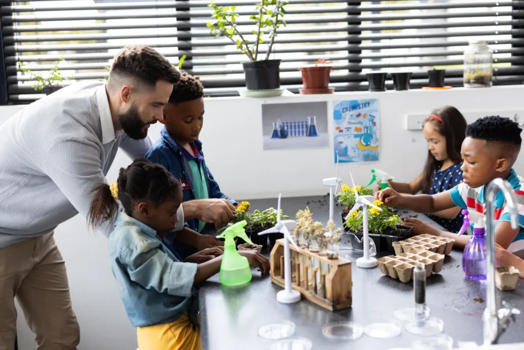 A main and children at a table with plants